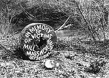 a round millstone painted with the words "in memory of victims of haun's mill massacre"