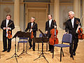 Image 16A modern string quartet. In the 2000s, string quartets from the Classical era are the core of the chamber music literature. From left to right: violin 1, violin 2, cello, viola (from Classical period (music))