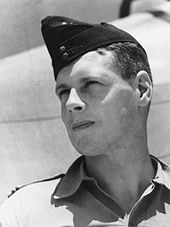 Outdoor head-and-shoulders portrait of man in tropical military uniform with forage cap.