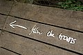 The trail is marked with metal direction signs, designed to look hand-written