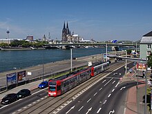 Light rail trainset in front of the river Rhine and Cologne Cathedral