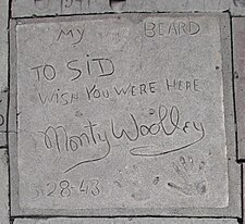 Monty Woolley's concrete tile showing, from the top, the words "My beard" adjoining his beard imprint, the inscription "To Sid [Grauman] Wish you were here", his signature, the date "5-28-43", and his handprints