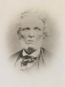 Photograph containing head and shoulders of a man