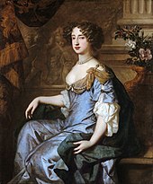 Formal seated portrait of Mary II. She wears a grey satin decollatage dress and a blue satin cloak with gold swathes at her shoulders. Her hair is formally arranged in curls and she wears a necklace of large grey pearls.