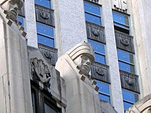 One of the "giants of finance" above the 19th floor. This is a carved head atop a stone pier, looking downward.