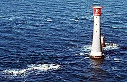 The Eddystone Rocks, with current lighthouse and the remnants of previous tower