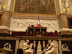The desk of the President of the Assembly, designed by Jacques-Louis David, and the tribune of the chamber, with bas-relief of History and Fame by François-Frédéric Lemot (1797–98)