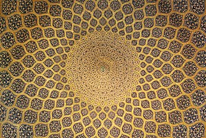 The interior of the dome which is inset with a network of lemon-shaped compartments, which increase in size as they descend from a formalised peacock at the pattern inlaid on plain stucco