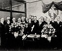 Opening festivities of the Consulate of Lithuania in Chicago in 1924. The Coat of arms of Lithuania Vytis (Waykimas) is seen in the background.