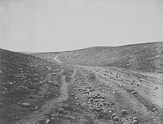 A view of the "Valley of the Shadow of Death" near Sevastopol, taken by Roger Fenton in March 1855. It was so named by soldiers because of the number of cannonballs that landed there, falling short of their target, during the siege.[33]