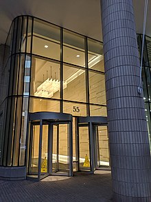 Street level view of 55 Broadway, with revolving doors visible which lead to lobby