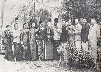 A group photograph of 13 men and women