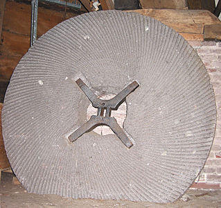 Millstone and shackle, X-shaped metal part