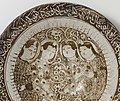 Stonepaste dish from 13th century Iran with a poem in naskh around the rim.