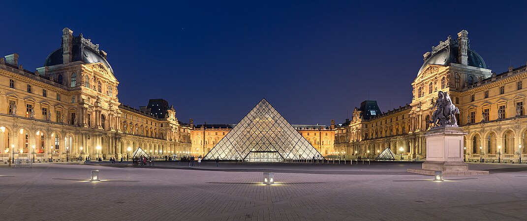 The Courtyard of the Louvre Museum at night.