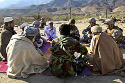 US Army Psyops personnel meet with village elders from Mangow village in Laghman province