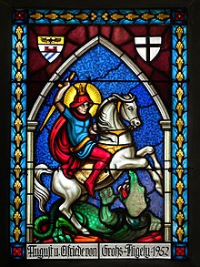 Stained glass art of a saint holding a sword and riding a horse, crushing a dragon