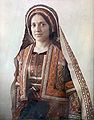 Woman from Ramallah wearing traditional Palestinian dress, including a taqsireh and smadeh (c. 1929–1946)
