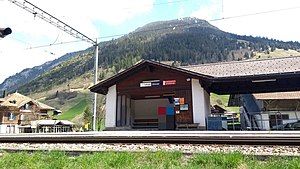 Shelter next to double-track railway line with mountain behind