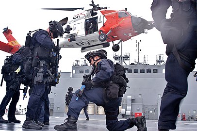 A Coast Guard Maritime Security Response Team (MSRT) executing a boarding action from an MH-60 Jayhawk helicopter.
