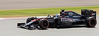 A picture of Fernando Alonso driving a McLaren MP4-30 formula one car during the 2015 British Grand Prix.
