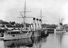 Two warships tied up at a wharf