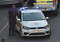 A Cape Town Law Enforcement officer with a Law Enforcement vehicle.