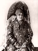 A woman wearing a large, rich, two-horned kokoshnik. 20th century. Photograph.