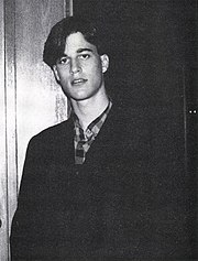 Black-and-white portrait of Berman as an adolescent with a curtained hairstyle wearing a checkered shirt and jacket