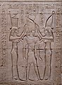 Pharaoh Ptolemy VIII between the goddesses Wadjet (symbolizing lower Egypt) and Nekhbet (symbolizing upper Egypt). Bas-relief on wall of Temple of Edfu, Egypt