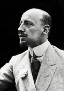 Black and white photograph of Gabriele D'Annunzio wearing a suit and looking to the side