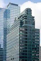 Tall green building with the words "McGraw-Hill" across the top floors, with a taller glass building behind