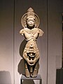 Yellow sandstone sculpture of a standing deity, 11th century CE, Rajasthan.