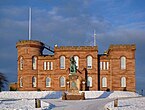 Inverness Castle in winter with the statue of Flora MacDonald in the foreground