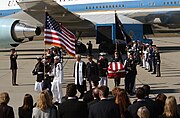 Honor and color guards carry the casket of former President Ronald Reagan after it is removed from the Boeing VC-25 Special Air Mission (SAM) 28000 in California.
