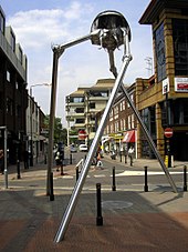 modern street scene with tall silver metal three-legged structure