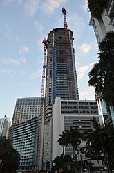 Panorama Tower under construction in October 2016 at about 60 floors with large multi-use pedestal (primarily parking) seen from Brickell Bay Drive.