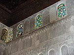 Stucco decoration and coloured glass windows in the upper walls of the prayer hall
