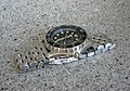 A watch with a segmented stainless steel watch bracelet.