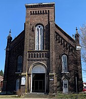 a brick church building, viewed from the front
