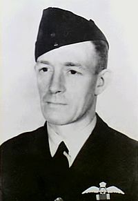 Portrait of man in dark military uniform with forage cap