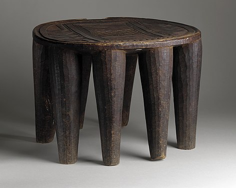 Wooden oval stool with incised carving; Los Angeles County Museum of Art.