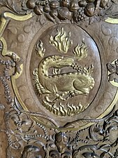 The emblem of Francis I, a salamander surrounded by flames, is found above each painting