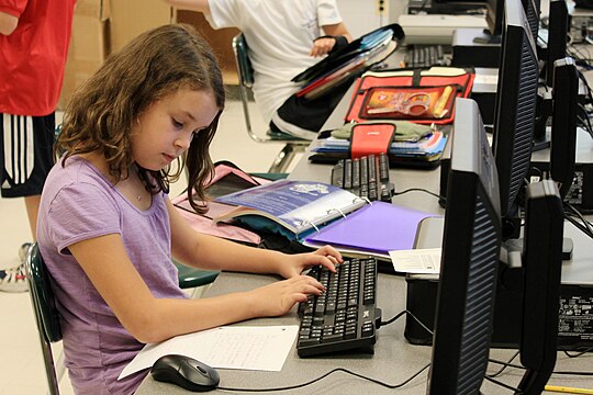 A girl using a computer to complete an assignment (2010)