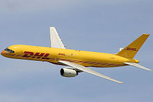 Side view of yellow twin-engine jet in flight