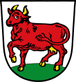 Markt Kühbach In Silber auf grünem Boden eine schreitende rote Kuh.