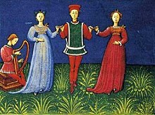 A man dancing with two women to harp music