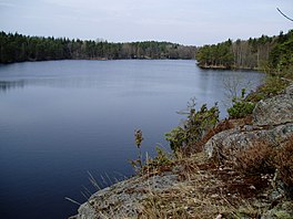 Photograph of Grändalssjön showing lake surface with rocky and wooded shores