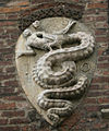 Depiction of the biscione swallowing a child, the coat of arms of the House of Visconti, on the Archbishop's palace in Piazza Duomo in Milan, Italy