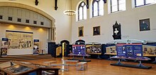 Large gothic hall with several display boards